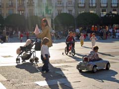 Kids play on a plaza at paseo time